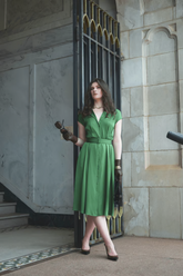 a lady in a long green dress